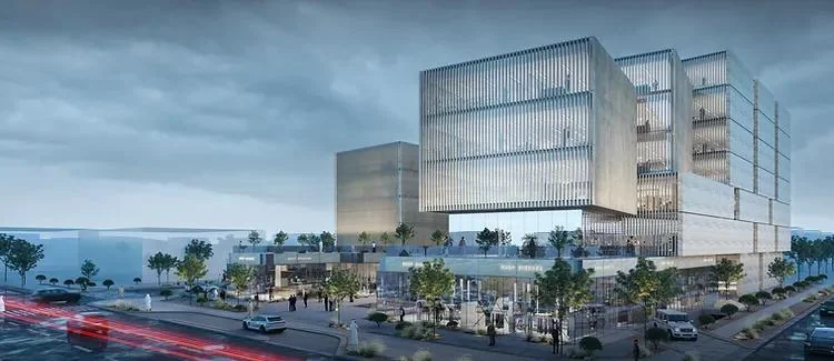 Evening visualisation of the building with illuminated glazing and passing traffic.